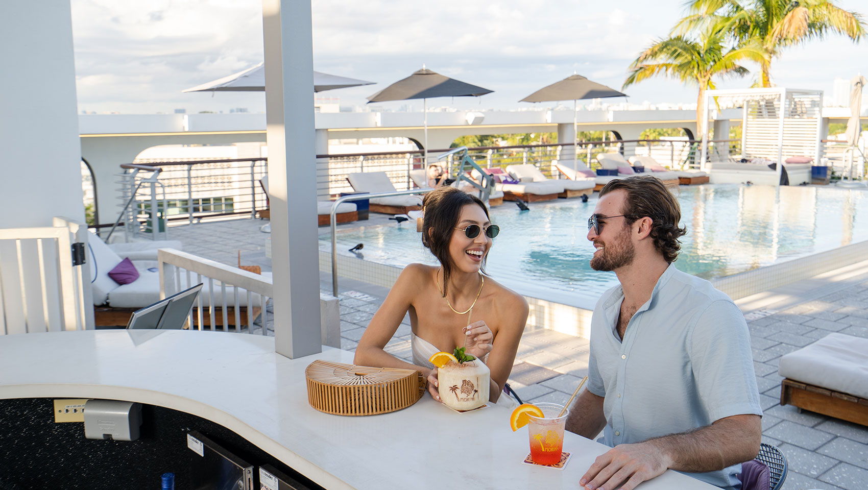 Man and Woman having drinks at the pool bar