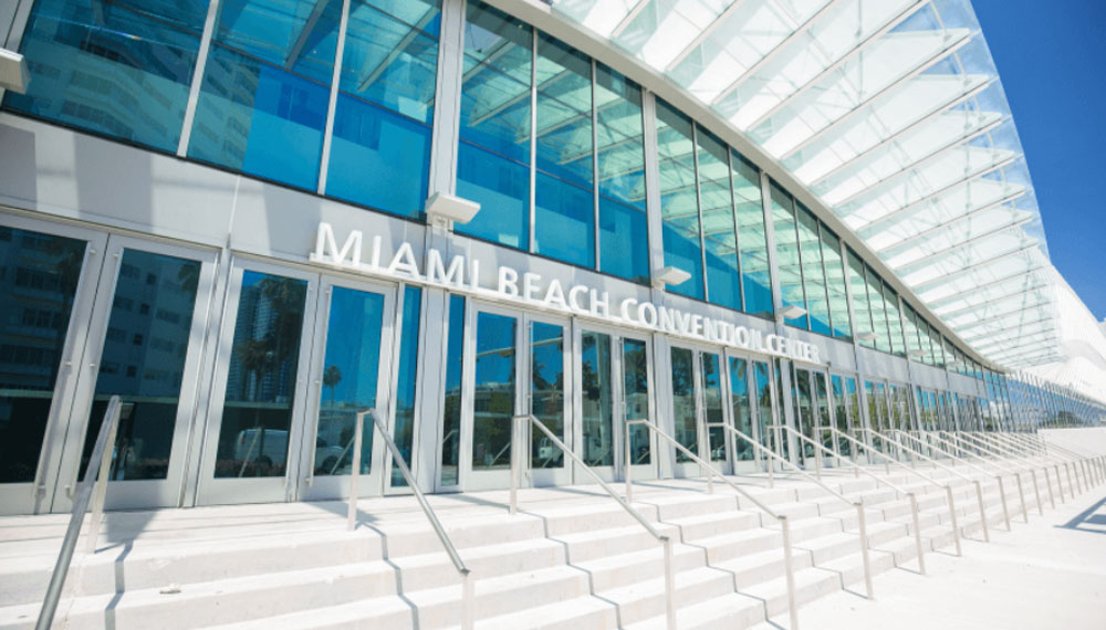 Newly renovated front exterior of the Miami Beach Convention with all glass windows.