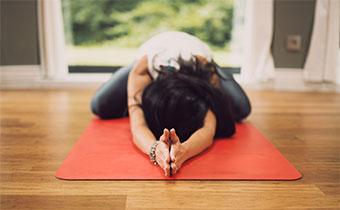 Woman on yoga mat in a pose