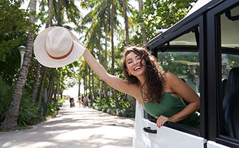 Woman waving out of car window