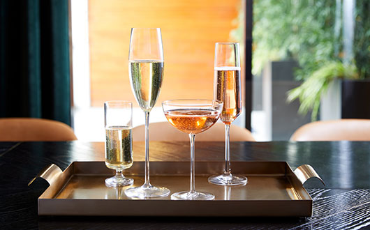 Multiple glasses of champagne on tray